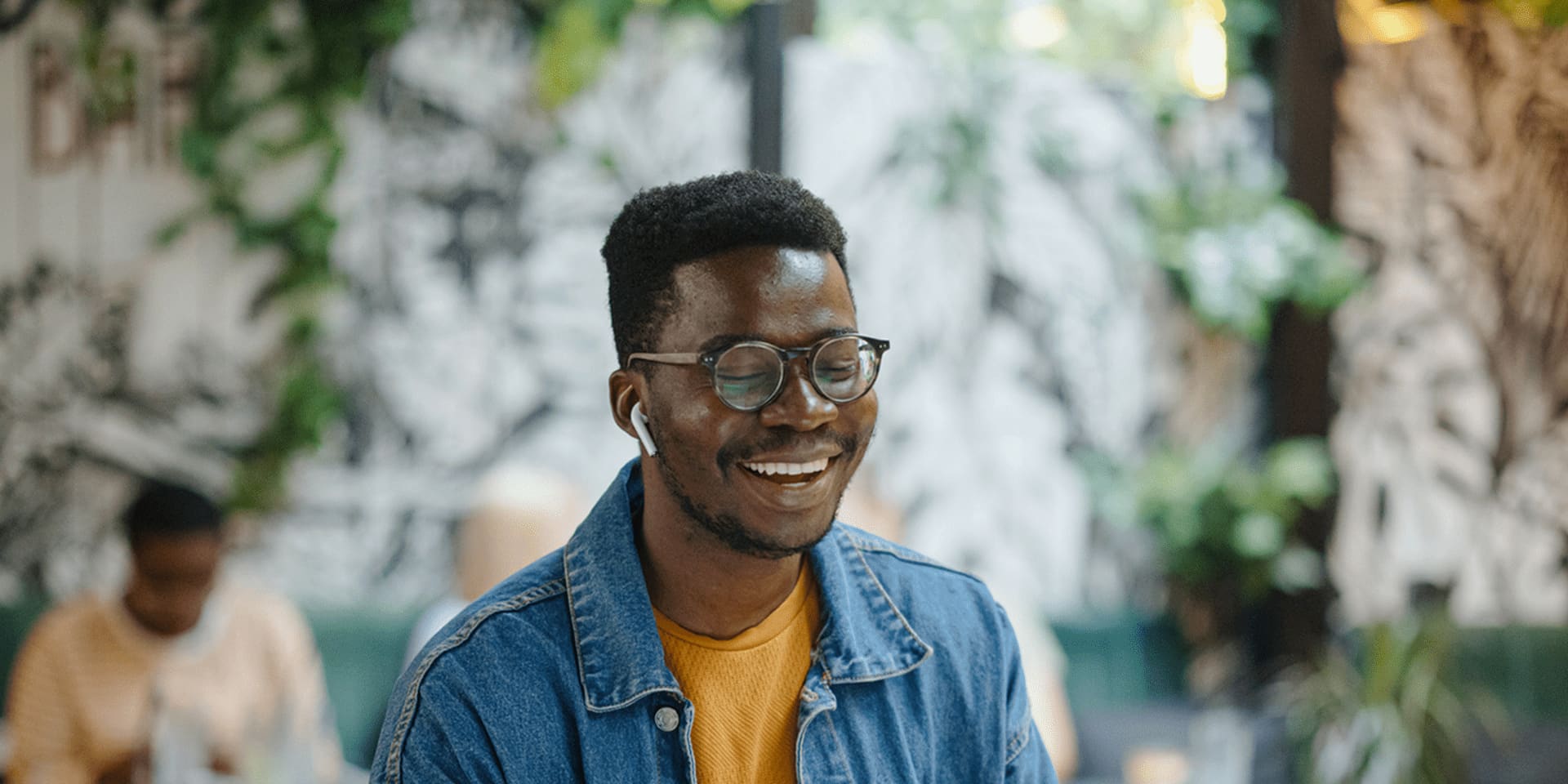 A young man wearing glasses creating his perfect cv on a laptop