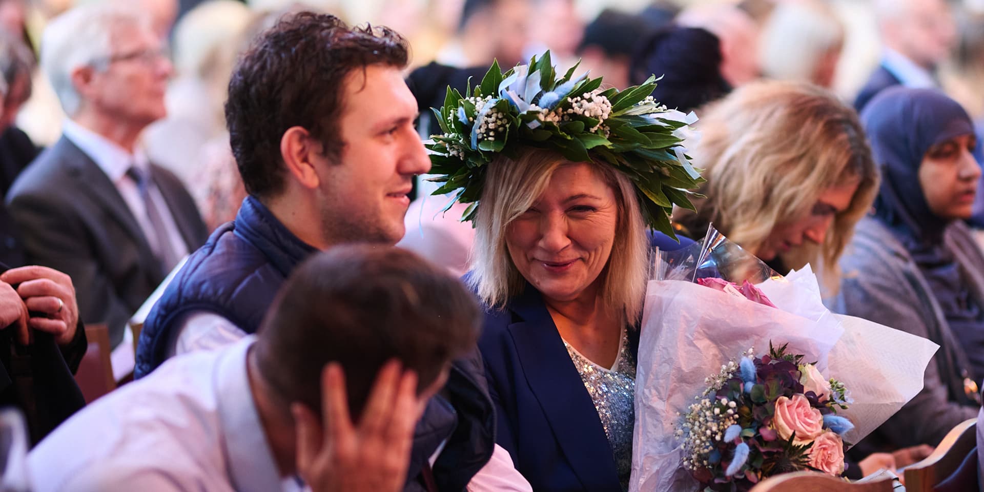 Celebrating Walbrook and LIBF graduate holds flowers at graduation ceremony in London