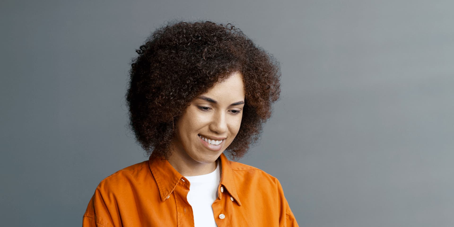 A young woman sat looking at a laptop, researching banking qualifications at LIBF