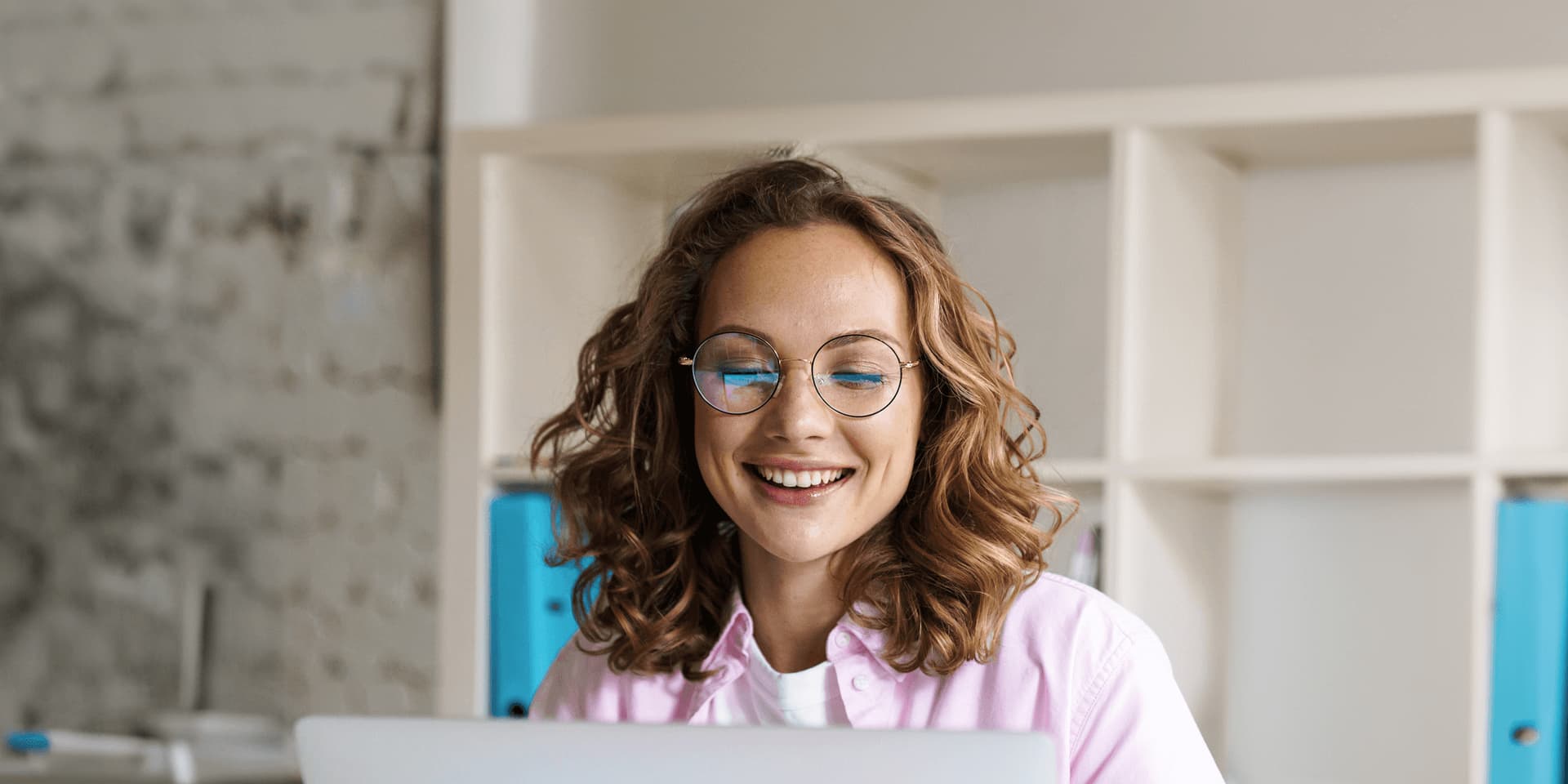 A young woman wearing glasses researching good things foundation