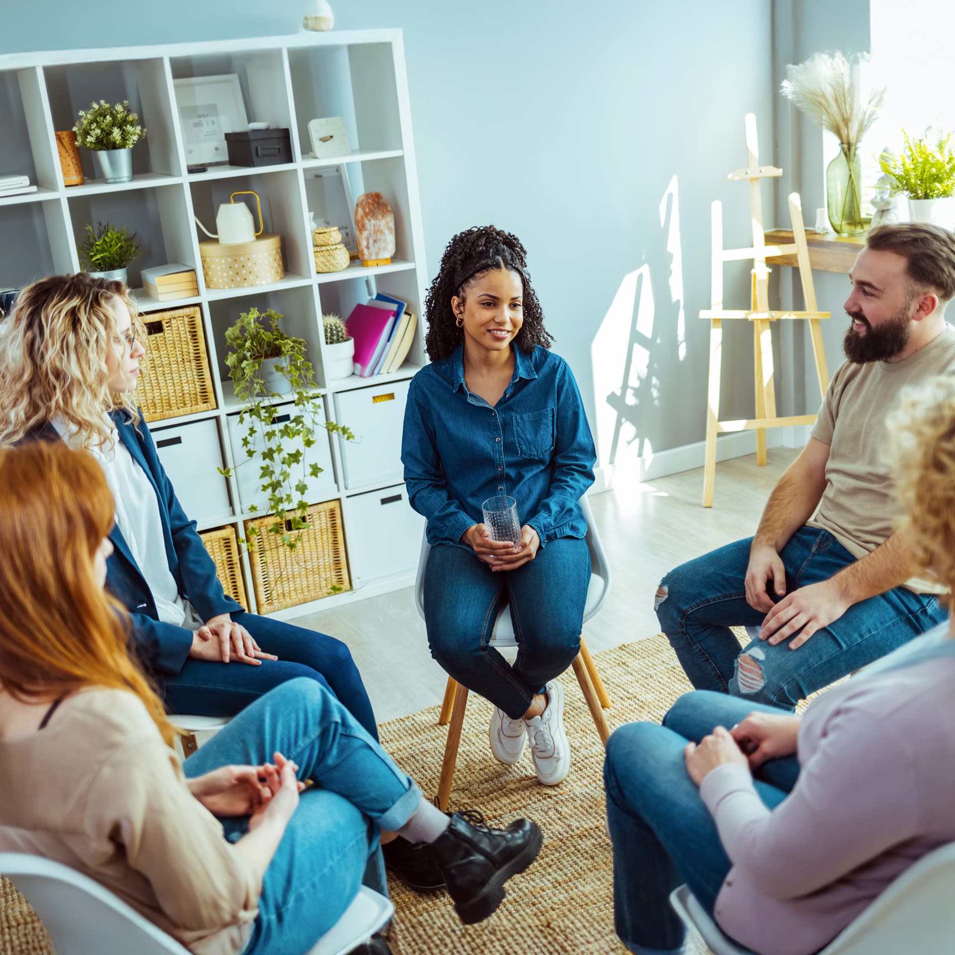 Group therapy being led by a clinical psychology graduate at the end of their academic year.