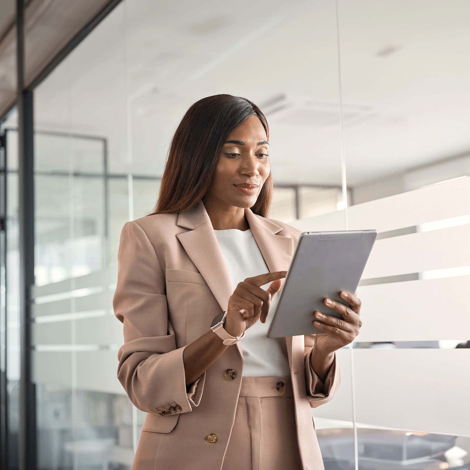 A young woman holding an iPad researching the available professional qualifications