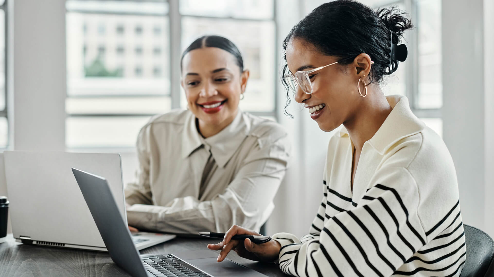 Two students studying online courses work on assessments as they learn online education.