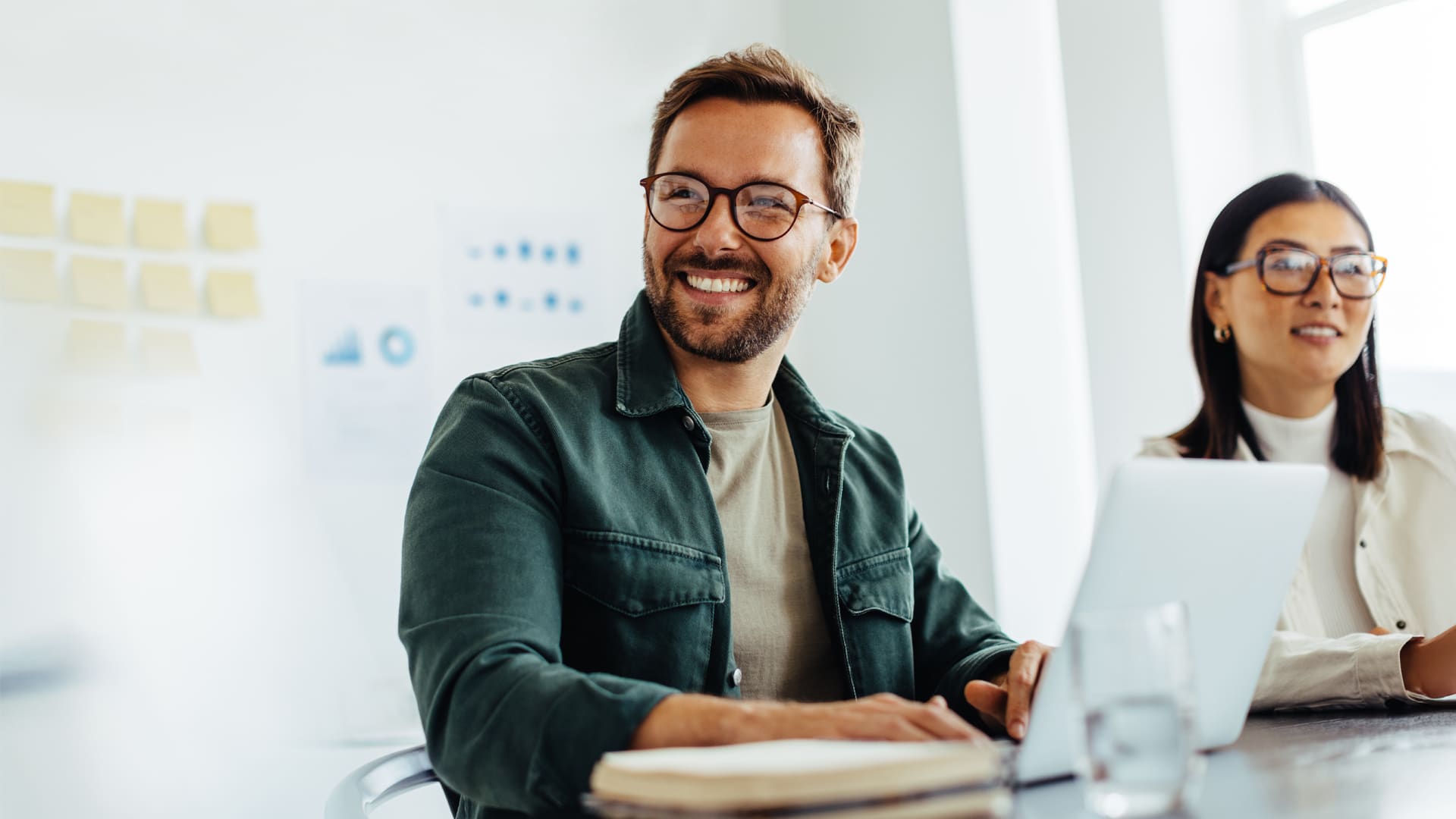 Confident MBA Project Management alum participates in a flexible workplace meeting, supporting team success.