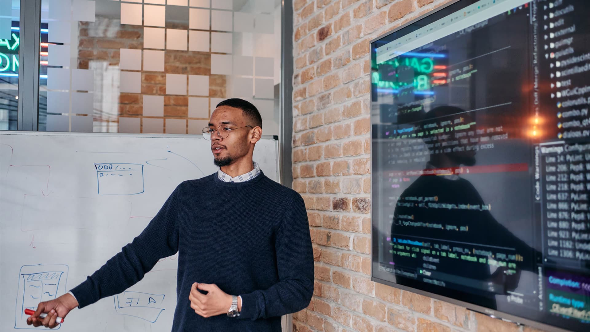 Systems engineer presents programming of operating systems in a modern office building.