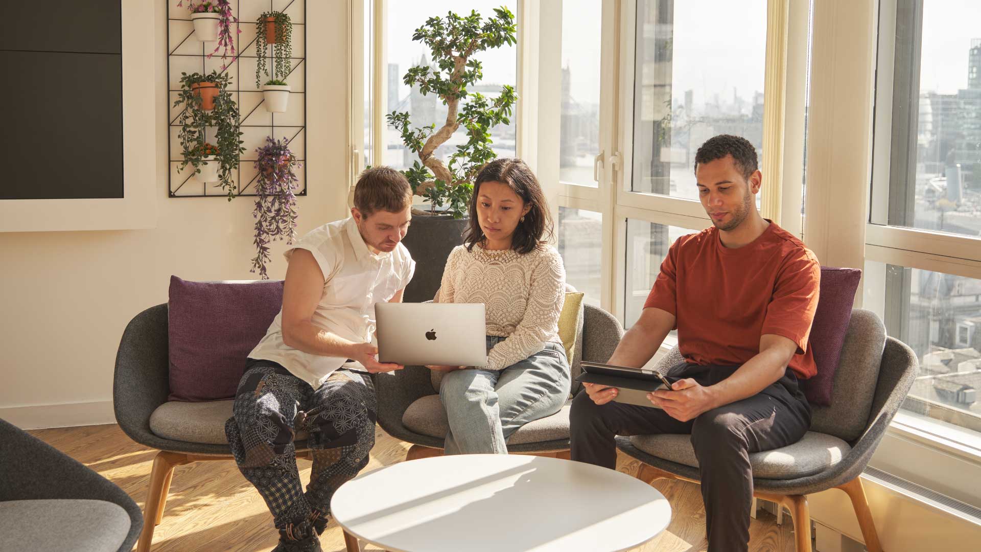 A group of Walbrook students studying their business courses from a laptop in London.