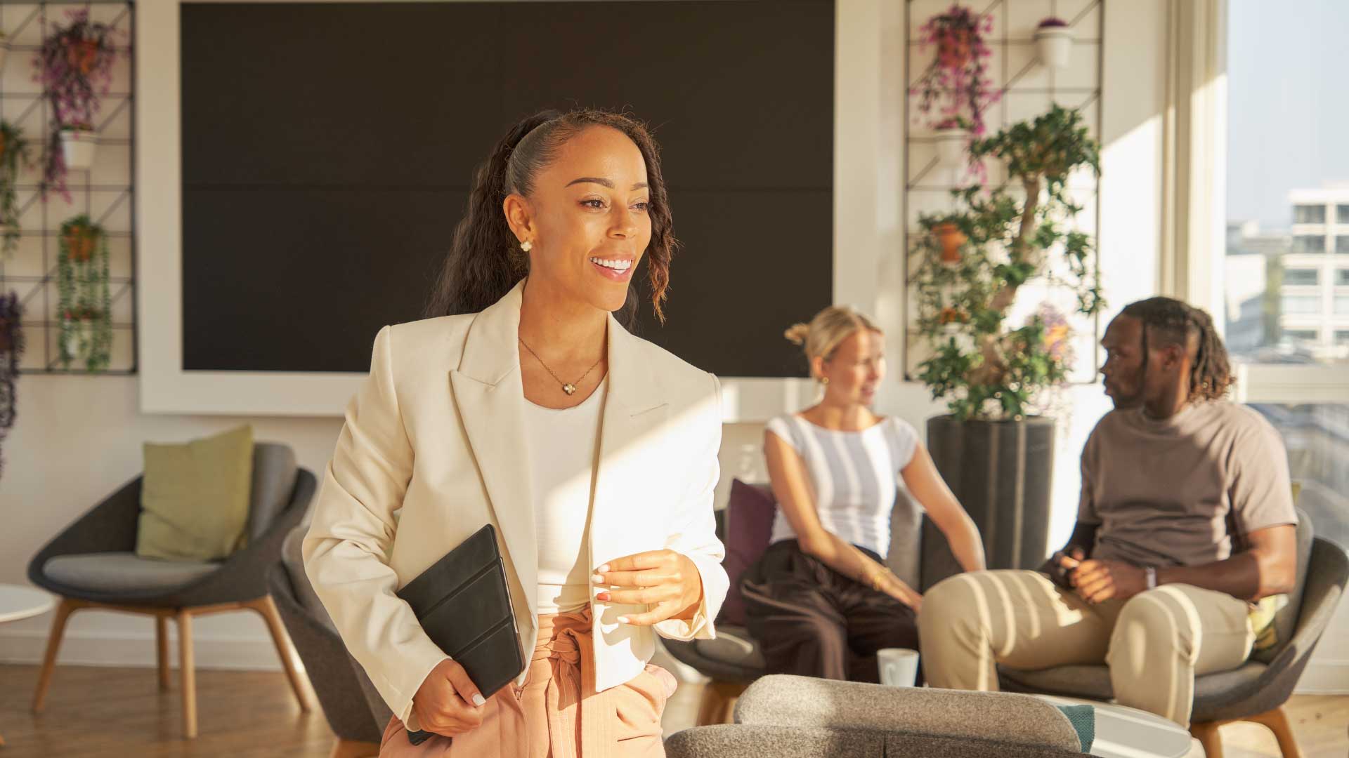 Young woman in a smart blazer at Walbrook campus waiting for her course class on Business and Management.